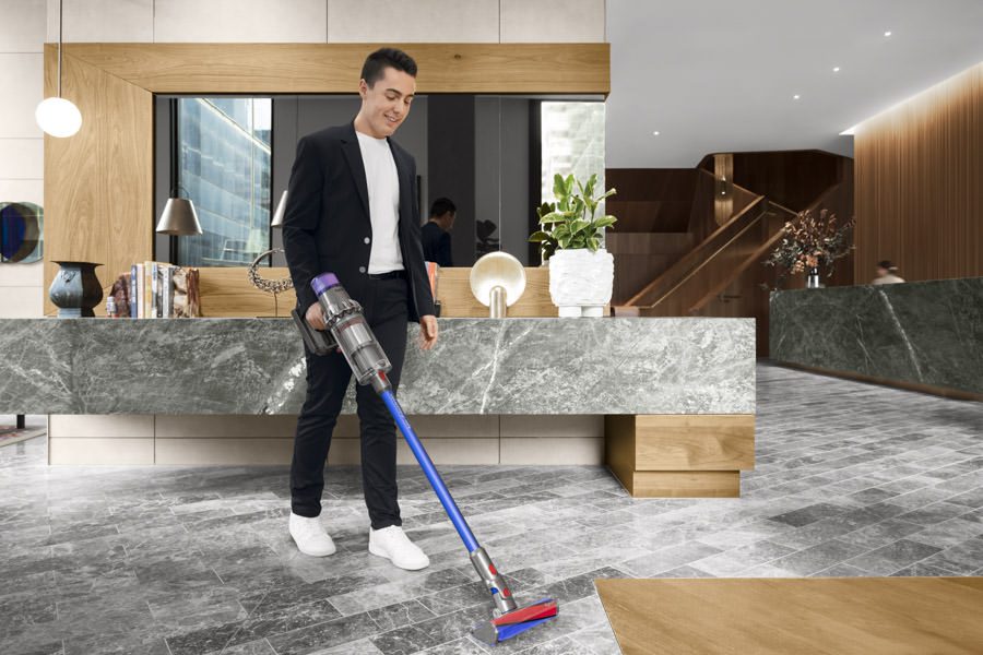 Product photography of a young man using a Dyson vacuum cleaner Product photography of a young man using a Dyson vacuum cleaner