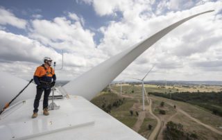 Industrial Photography of engineer on top of wind turbine